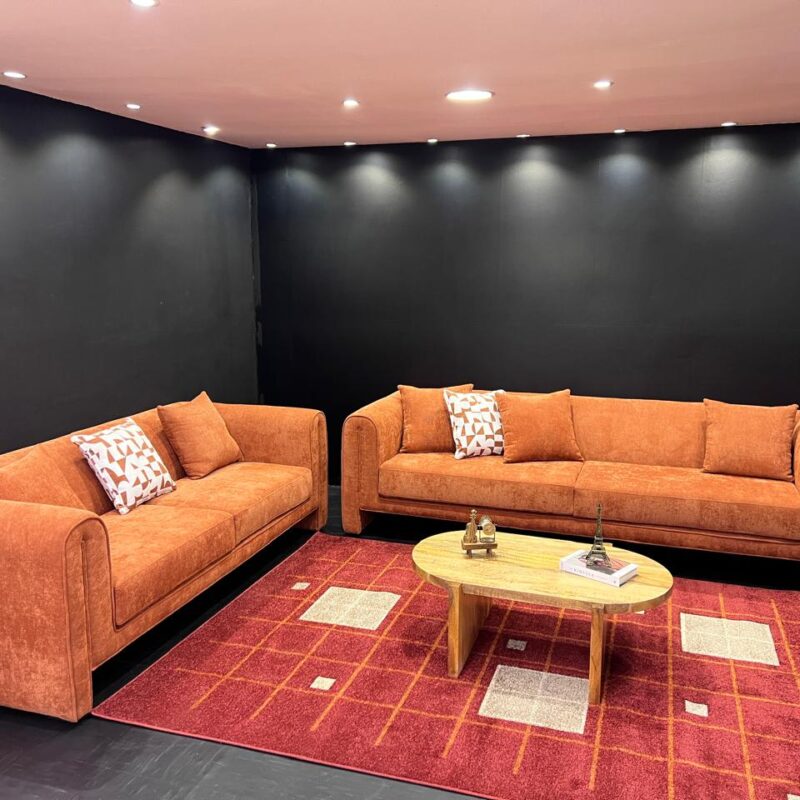A burnt orange sofa with a permanent back