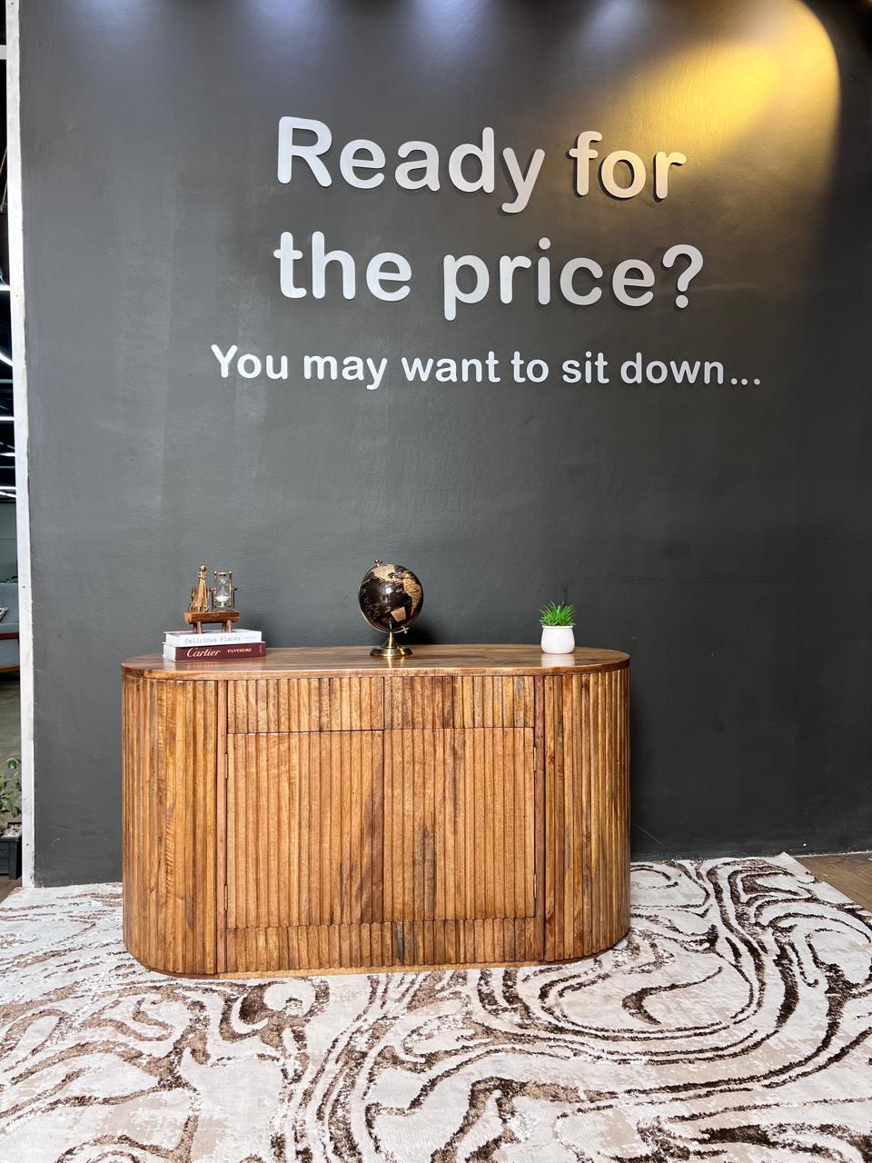 A fluted circular mango wood console