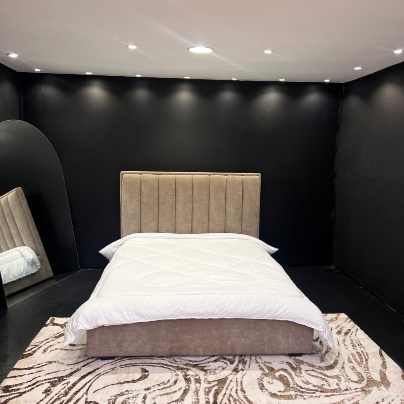A beige fabric bed