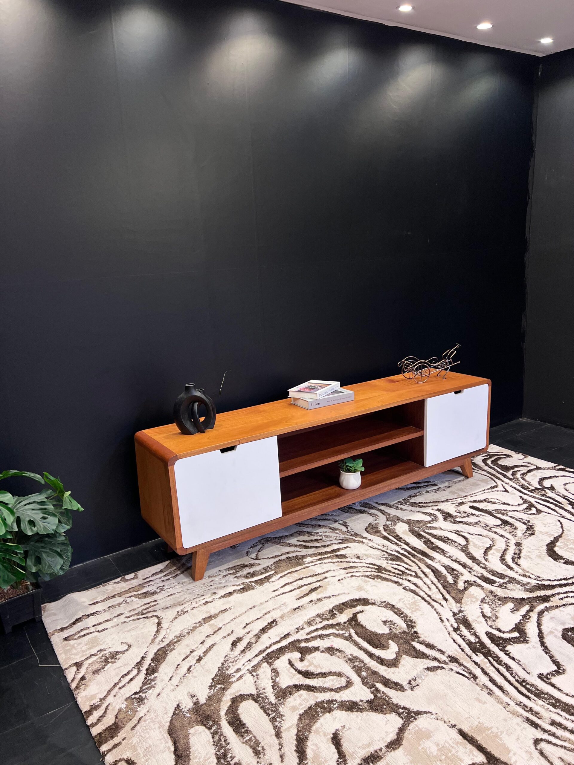 A natural mahogany tv stand paired with sleek white mdf doors